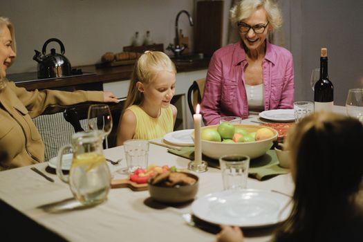 Family enjoying a cozy dinner together, showcasing warmth and togetherness.