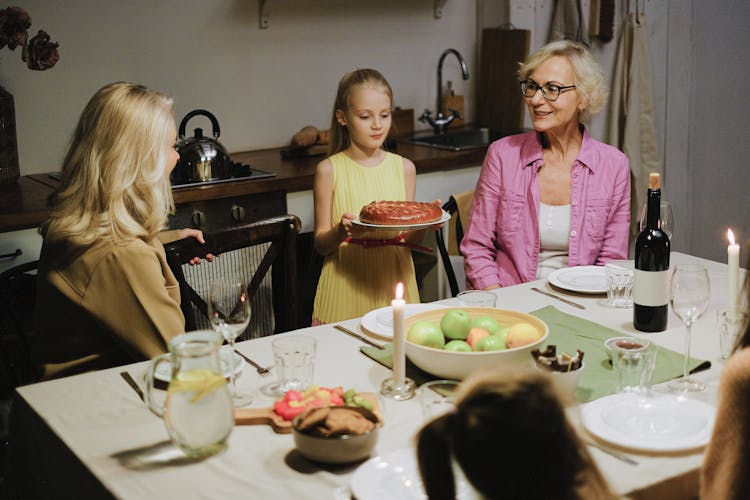 Girl In Yellow Dress Serving A Cake