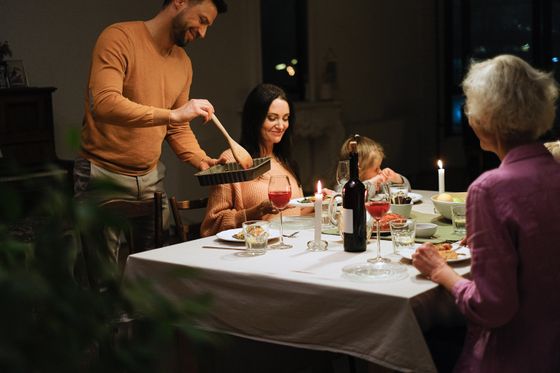 A family dinner served by candlelight — photo by Anna Shvets on Pexels