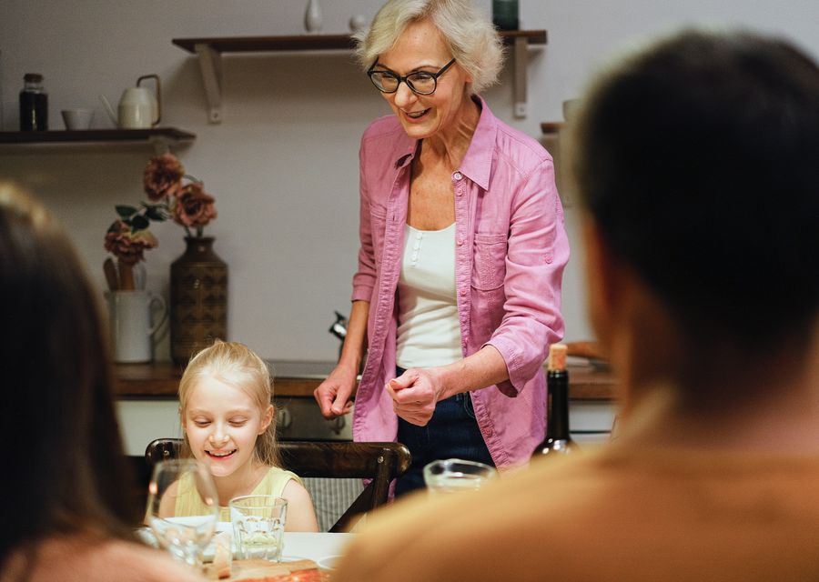 A family gathered around a dinner table at home.