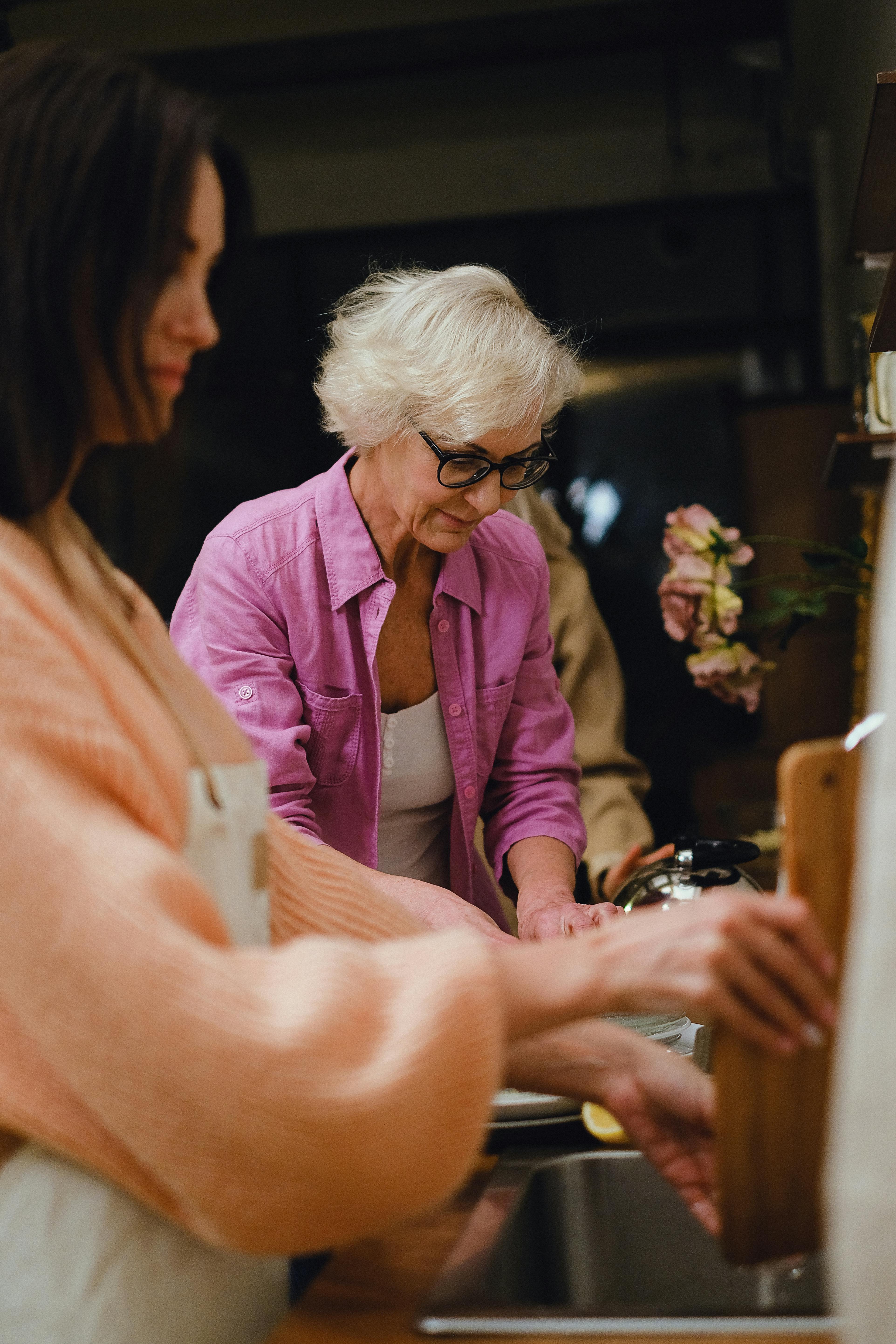 an elderly woman in purple blazer wearing eyeglasses