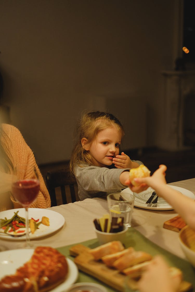 A Girl Sitting At The Table