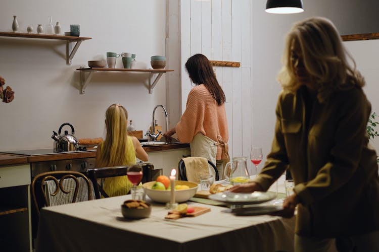 A Family Preparing Food On A Table