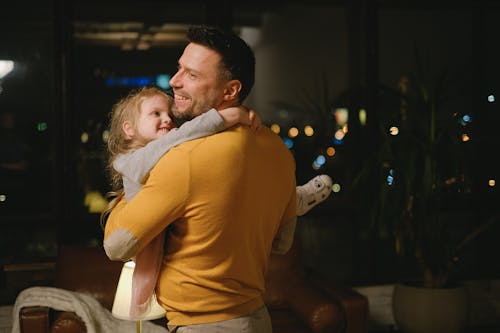 A Man Carrying his Young Daughter