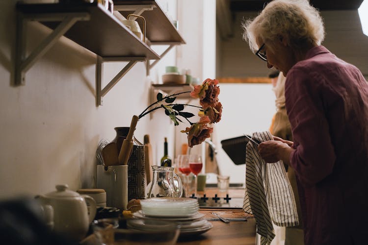 Woman Wiping The Dishes