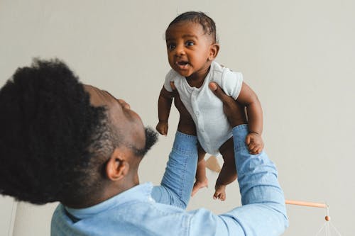 Man Carrying His Baby