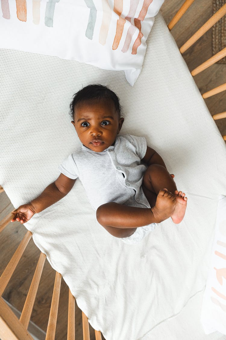 Baby Lying Down On A Crib