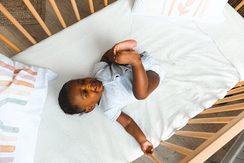 Free Overhead Shot of a Baby in a Crib Stock Photo