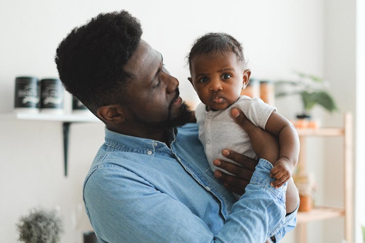 Father Carrying A Baby