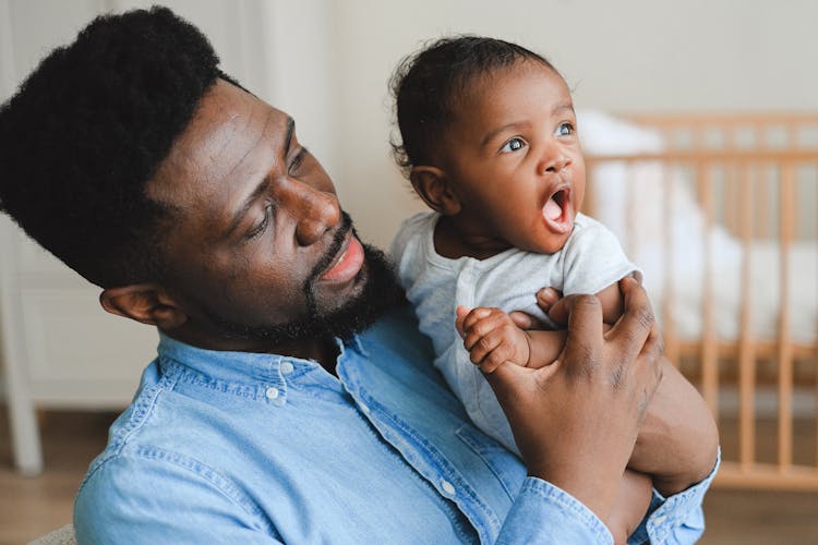 A Man Carrying His Child