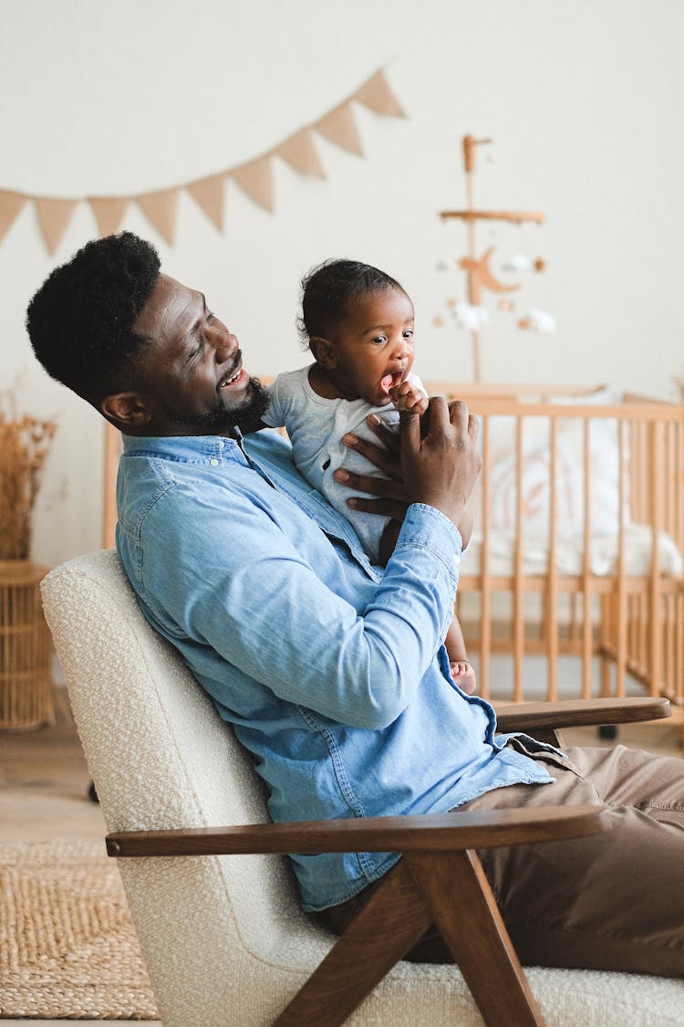 A Man Holding His Baby 