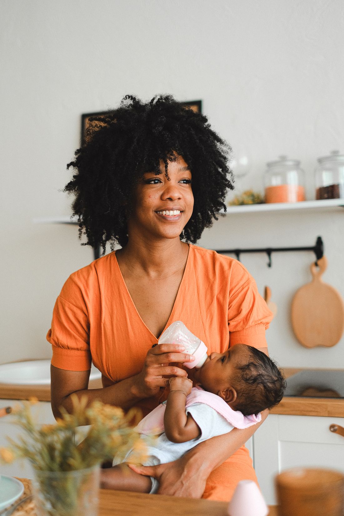 A mother feeding her baby with a bottle