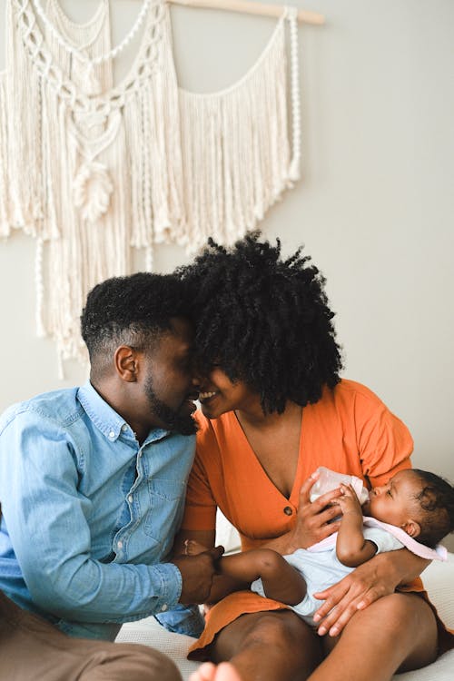 Free Happy Couple with Their Baby Stock Photo