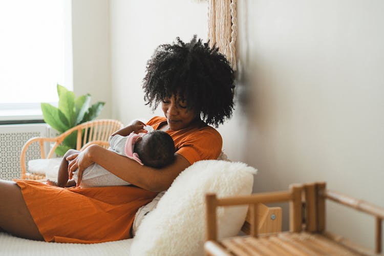 A Woman Cuddling Her Baby 