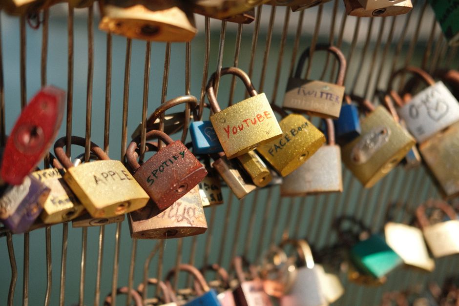 Close-up of colorful love padlocks on a bridge in Paris, symbolizing love and commitment.