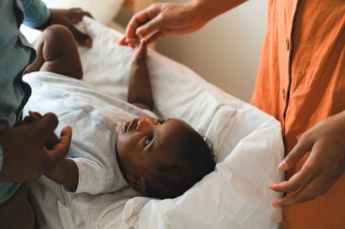 Free A Baby Boy in Gray Onesie Lying Down Stock Photo