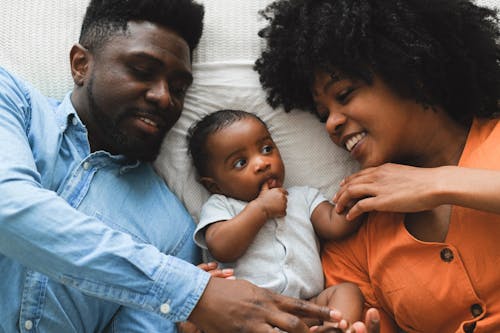 Couple and a Baby Lying on Bed