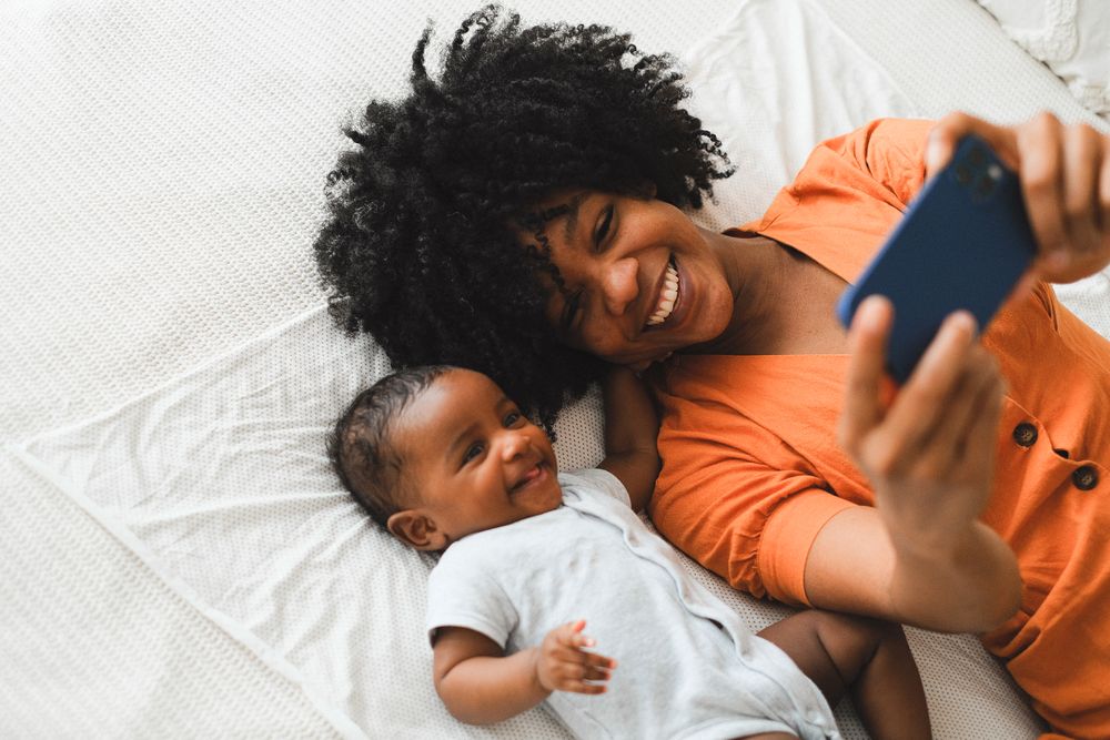 A smiling mother cuddling her baby