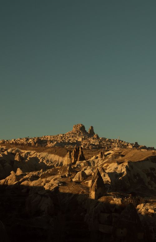 Free Discover the eroded rock formations of Cappadocia, Turkey at sunset, showcasing a stunning natural spectacle. Stock Photo