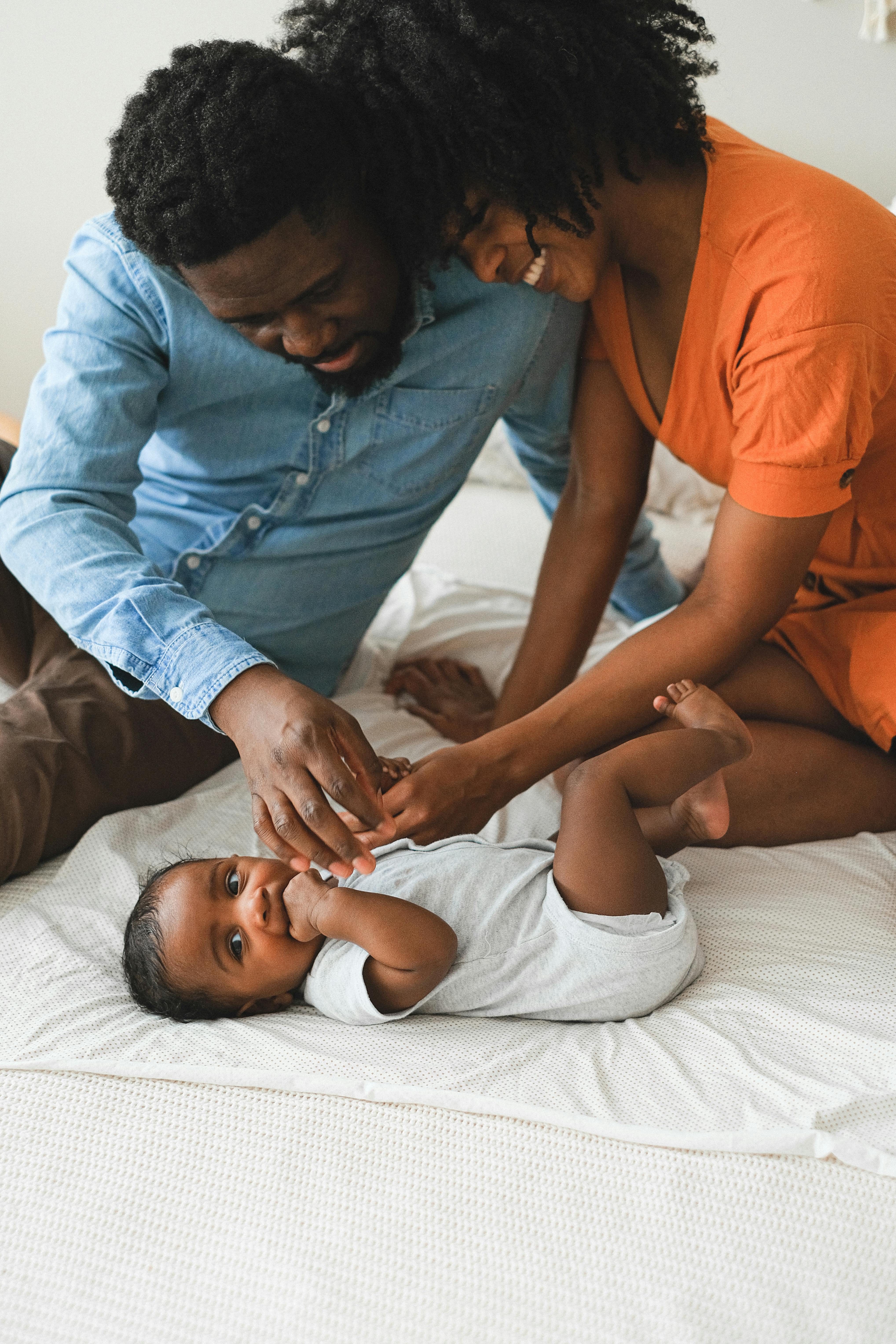 a man and a woman looking at their baby