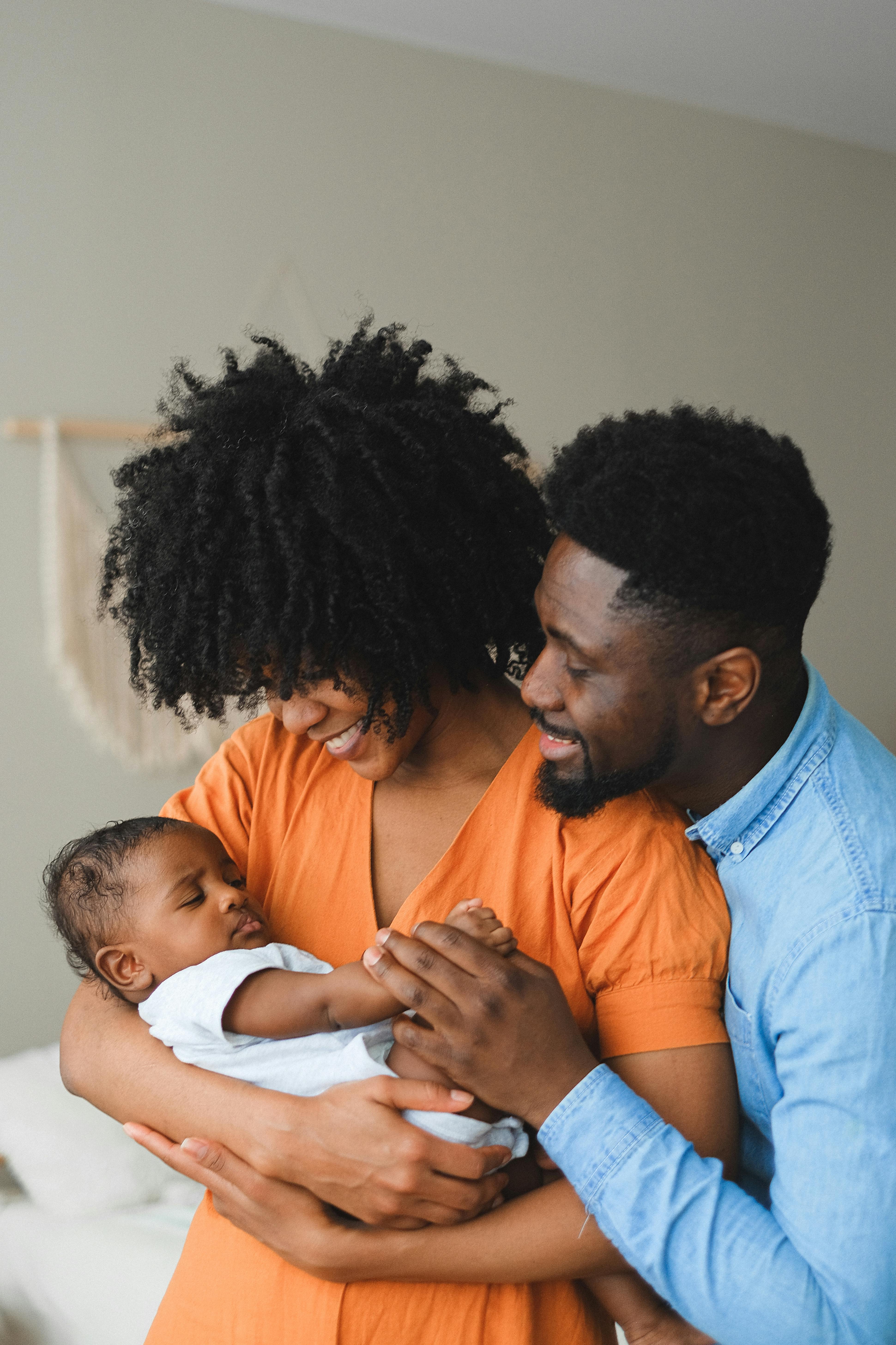 parents carrying a baby