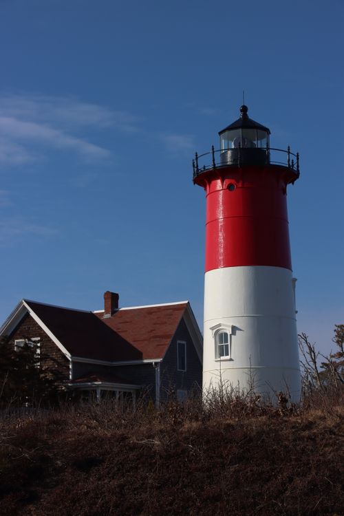 Free Iconic red and white Nauset Light in Eastham, MA against a clear blue sky. Stock Photo