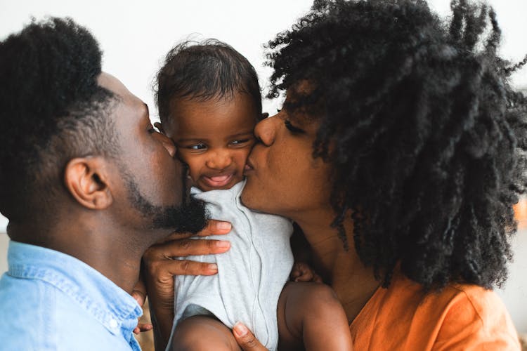 Couple Kissing A Beaby