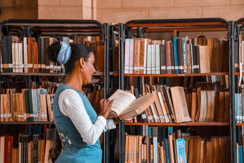 Woman Holding Book in Library
