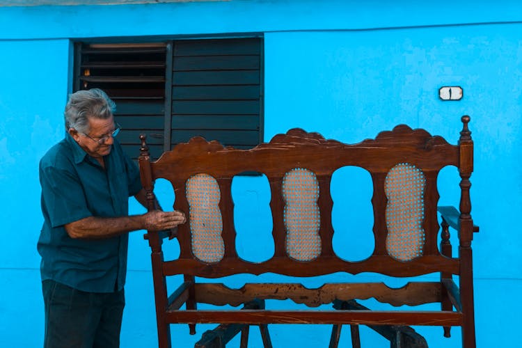 Man Renovating Vintage Bench