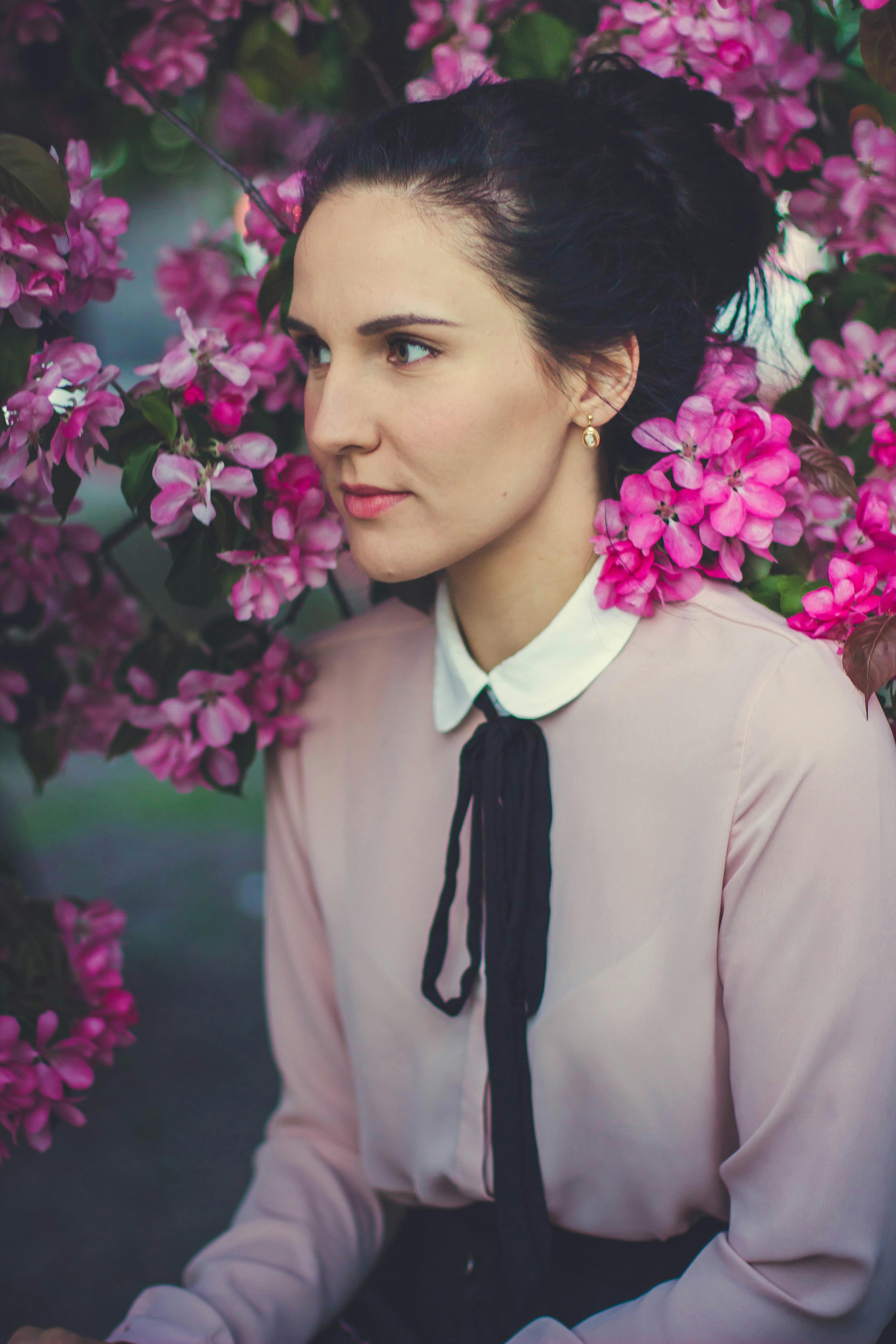 Woman Sitting Near Pink Petaled Flowers · Free Stock Photo