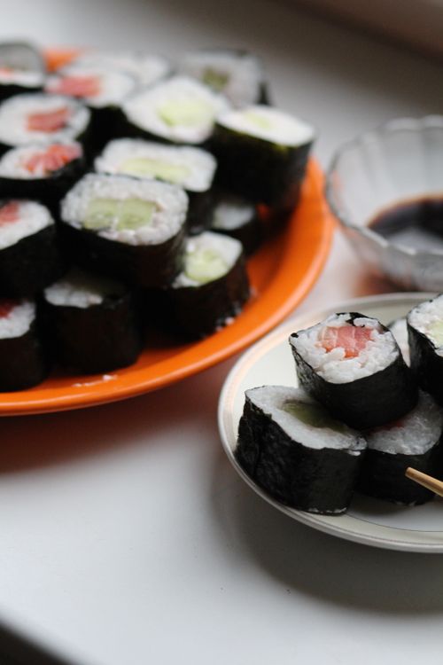 Free Delicious fresh sushi rolls with salmon and cucumber served with soy sauce. Stock Photo