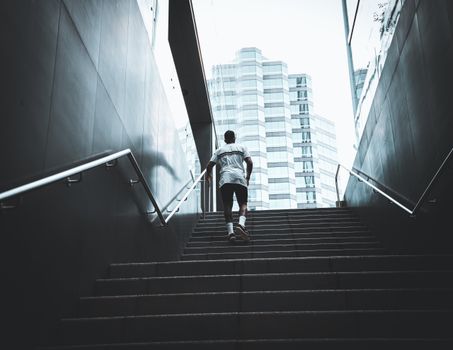 Low-Angle Shot of a Man in White Shirt Walking on Stairs