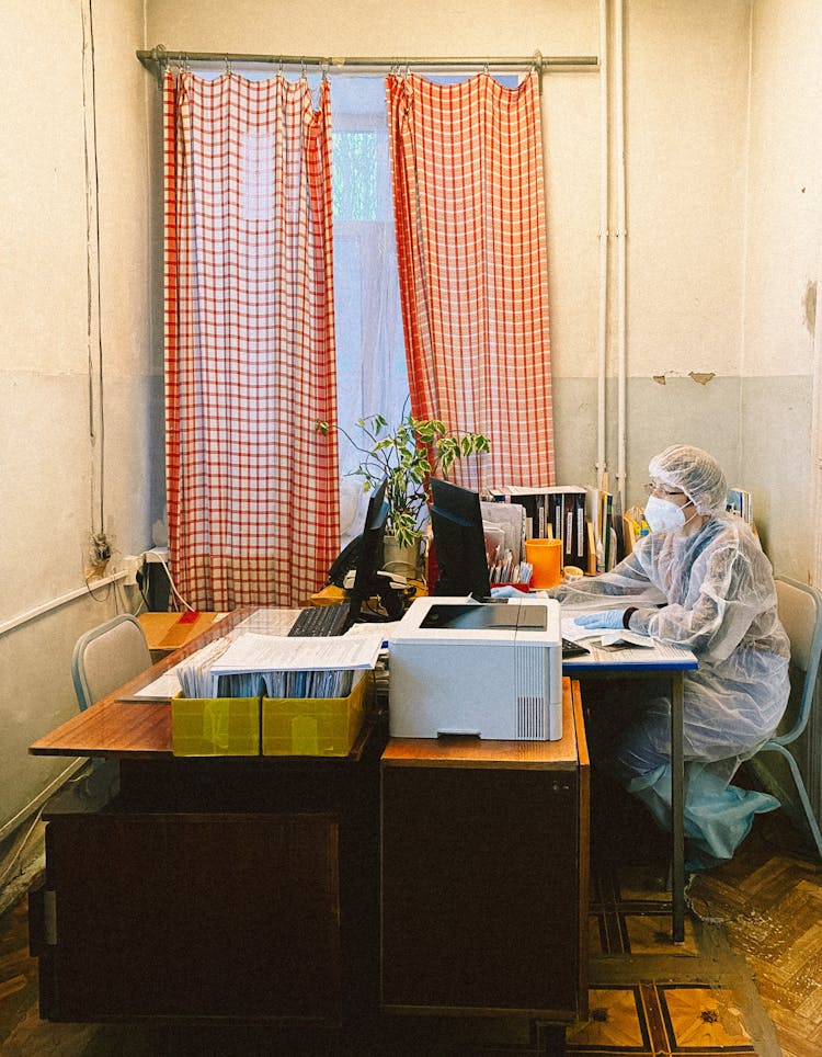 A Health Worker Working While Sitting