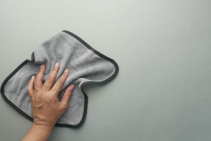 Cloth and vinegar wiping a surface clean