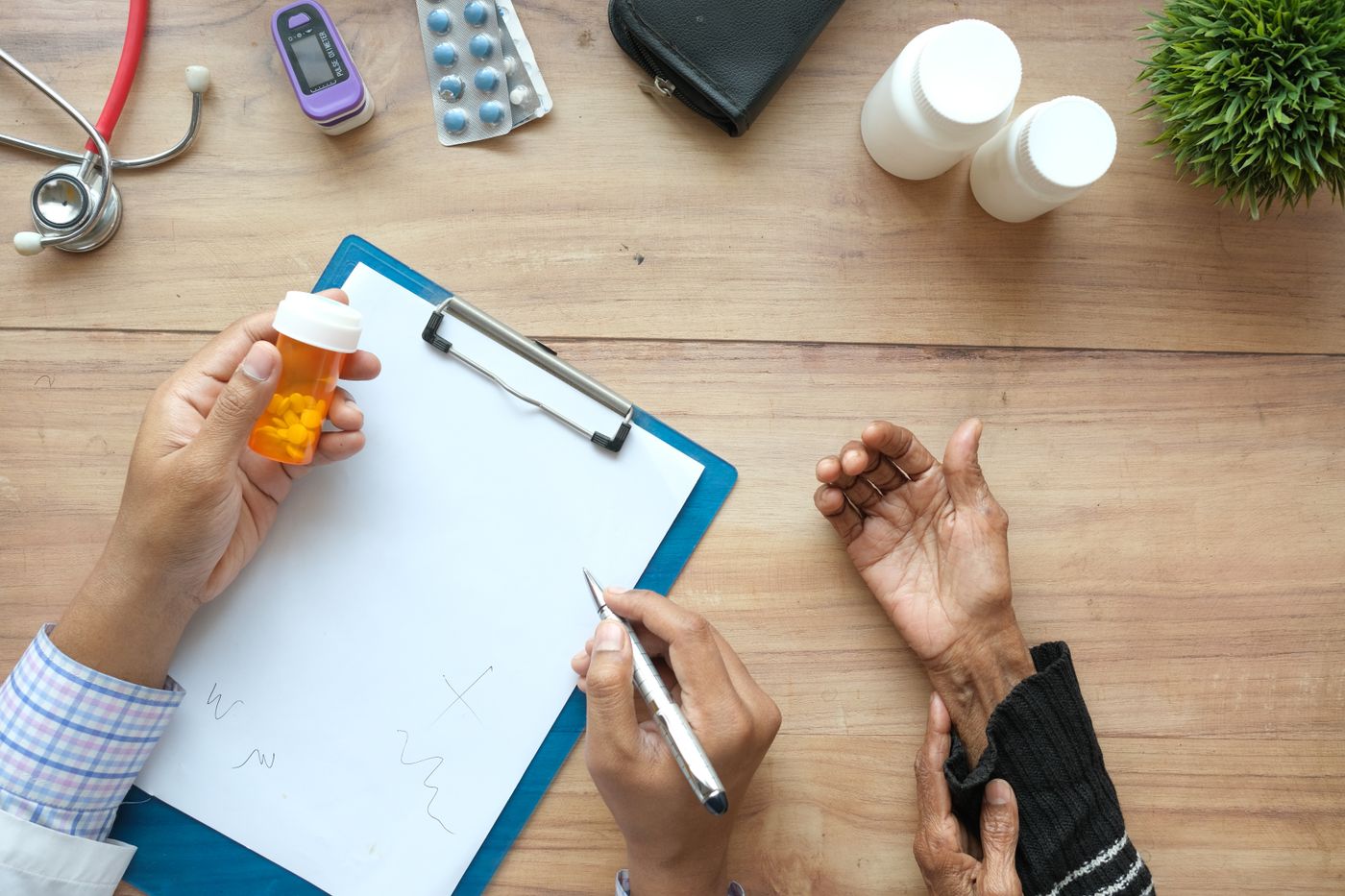 Healthcare professional reviewing medication and care information during a chronic care consultation