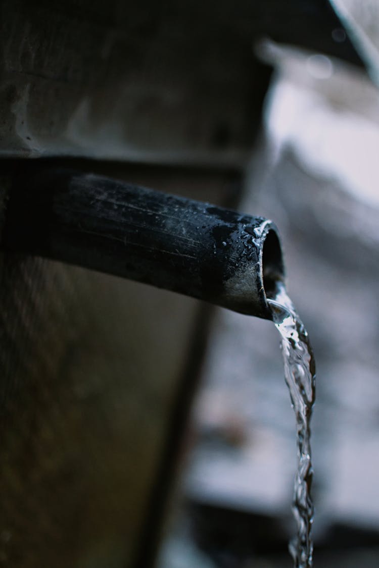 Water Flowing From Gray Steel Pipe