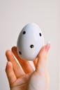 Close-Up Shot of a Person Holding an Easter Egg