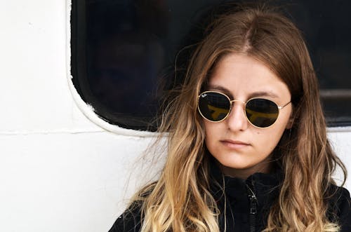 Woman in Black Jacket Wearing Sunglasses