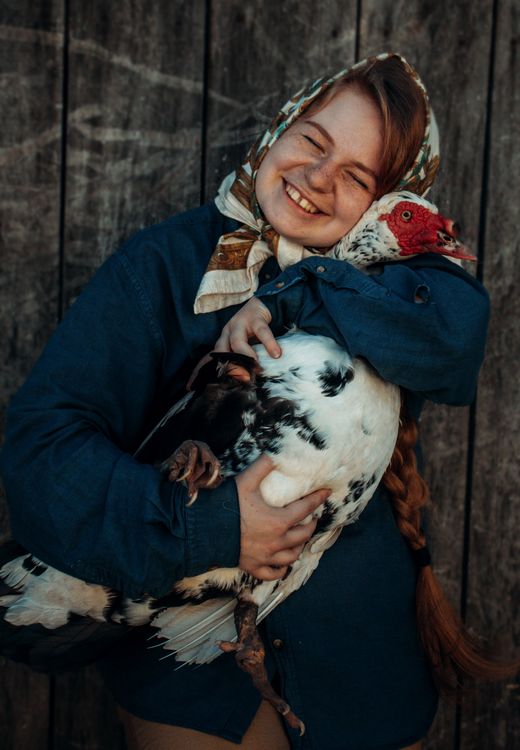 Girl Smiling and Hugging Turkey · Free Stock Photo