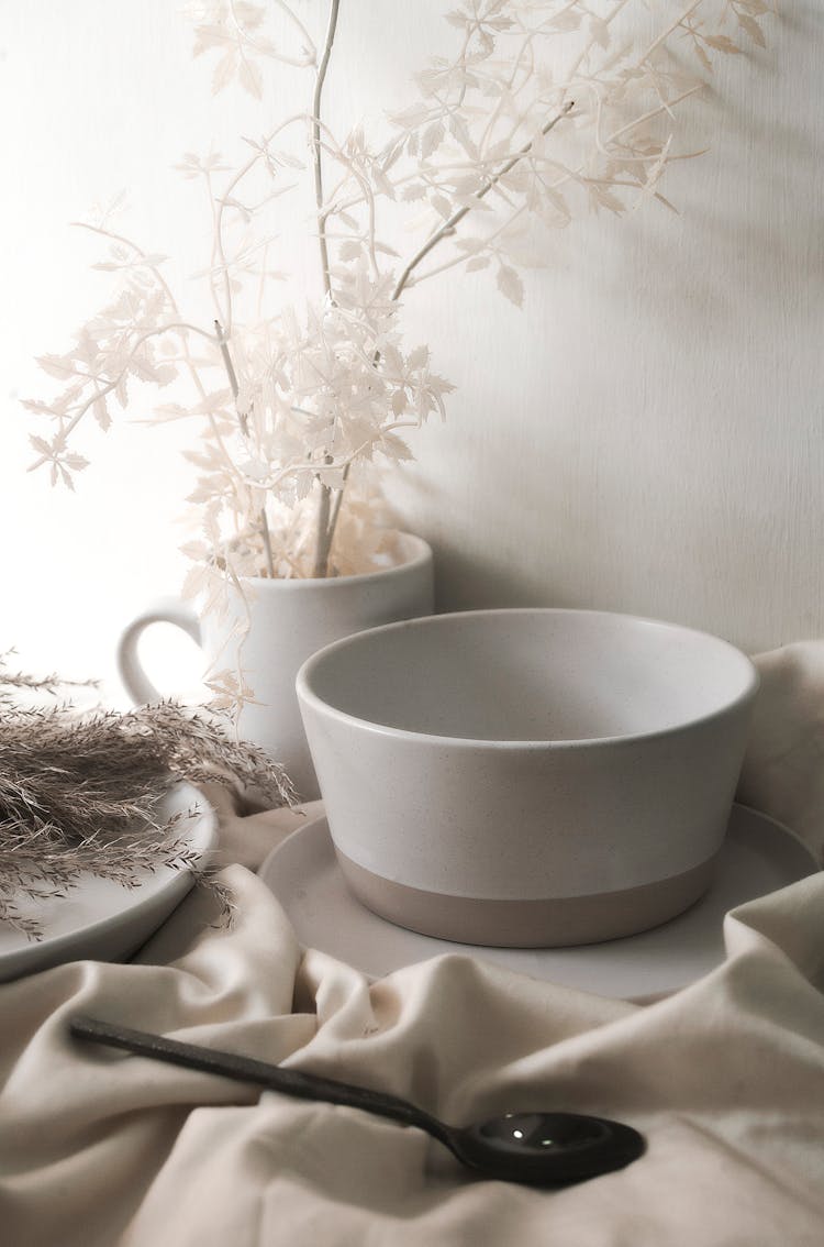 White Ceramic Teacup On White Textile