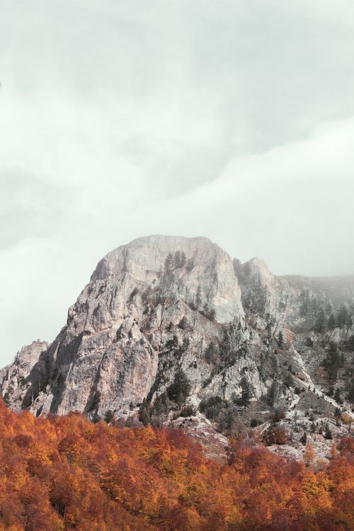 Free Dramatic view of Mount Shkodra in Albania surrounded by colorful fall foliage. A serene travel destination. Stock Photo