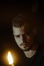 Man in Black Crew Neck Shirt Holding Lighted Candle