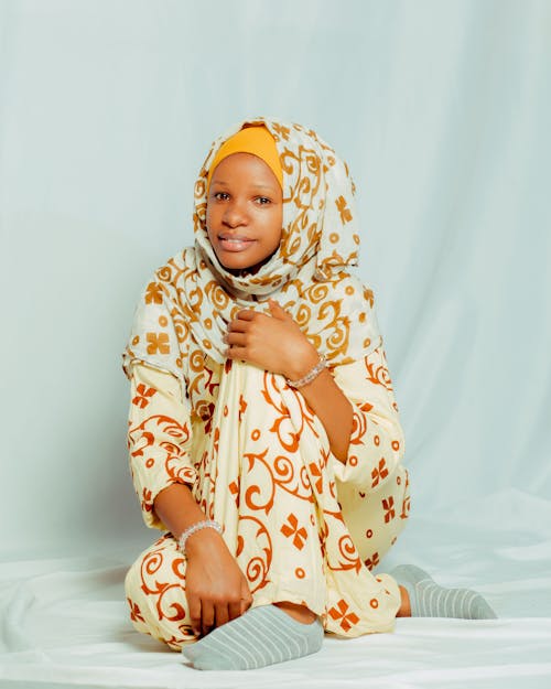 Smiling Young Woman Sitting in Printed Hijab