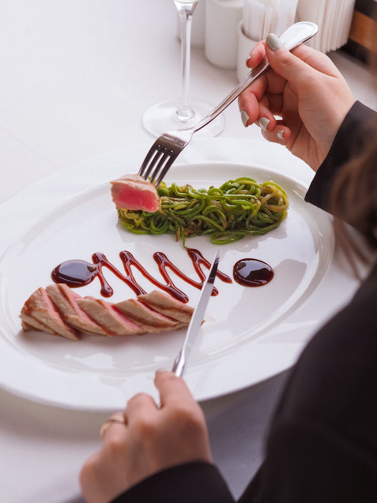 Woman Eating Dish With Tuna 