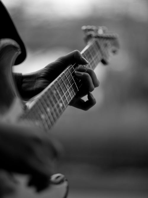 Free Grayscale Photo of a Person Playing Electric Guitar Stock Photo