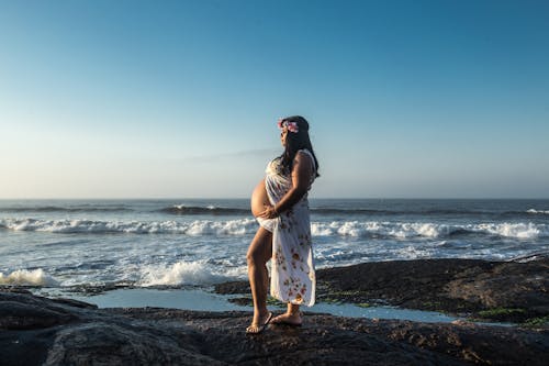 Free Maternity Shoot of a Woman on the Beach Stock Photo