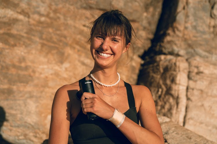 Woman Holding A Massage Gun