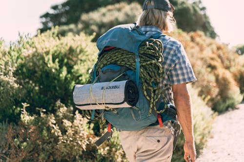 Free Back View of a Person Wearing a Backpack with Climbing Gear Stock Photo