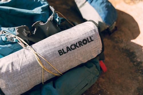 Free Close-up of hiking equipment featuring a Blackroll accessory, perfect for outdoor adventures. Stock Photo
