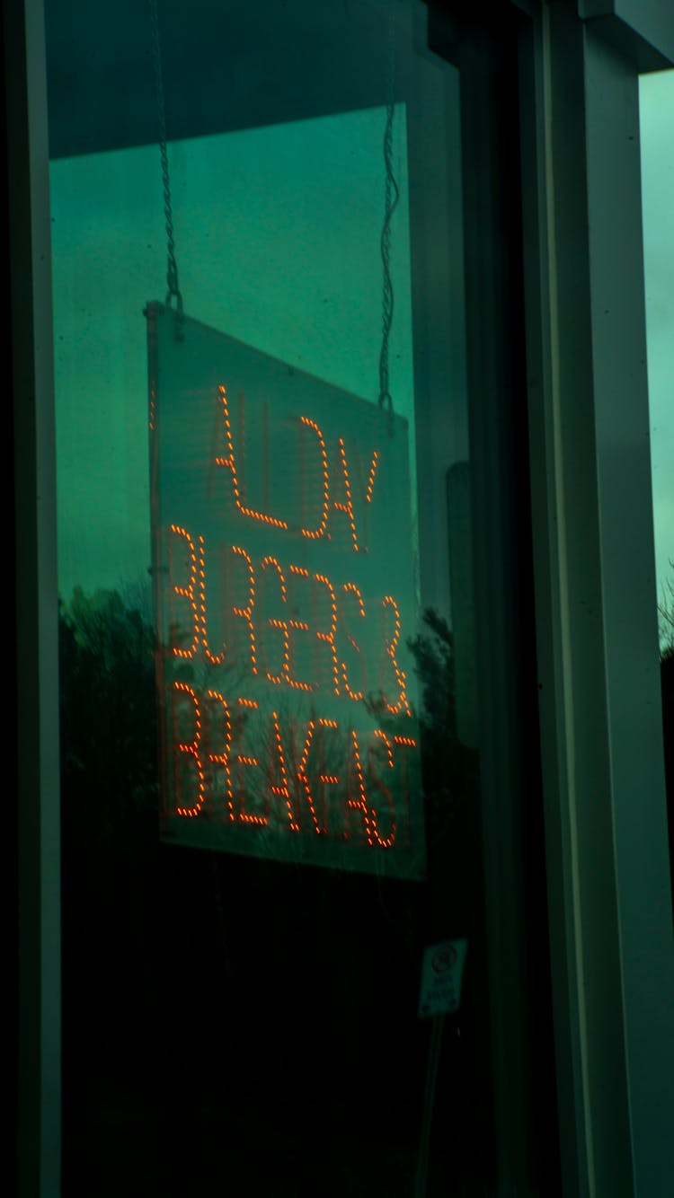 Advertisement On Neon Behind Window